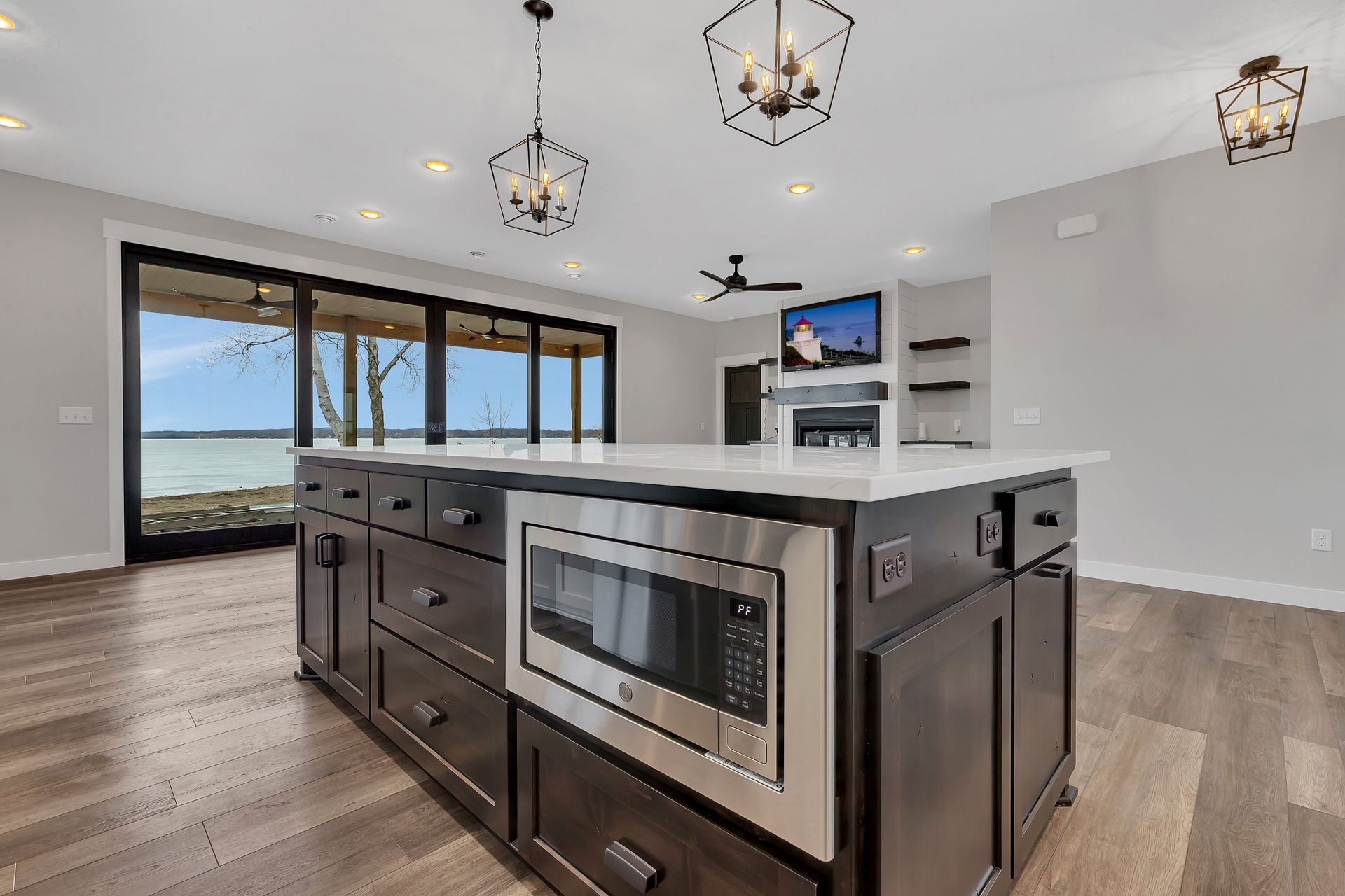 A kitchen with a large island and stainless steel appliances.