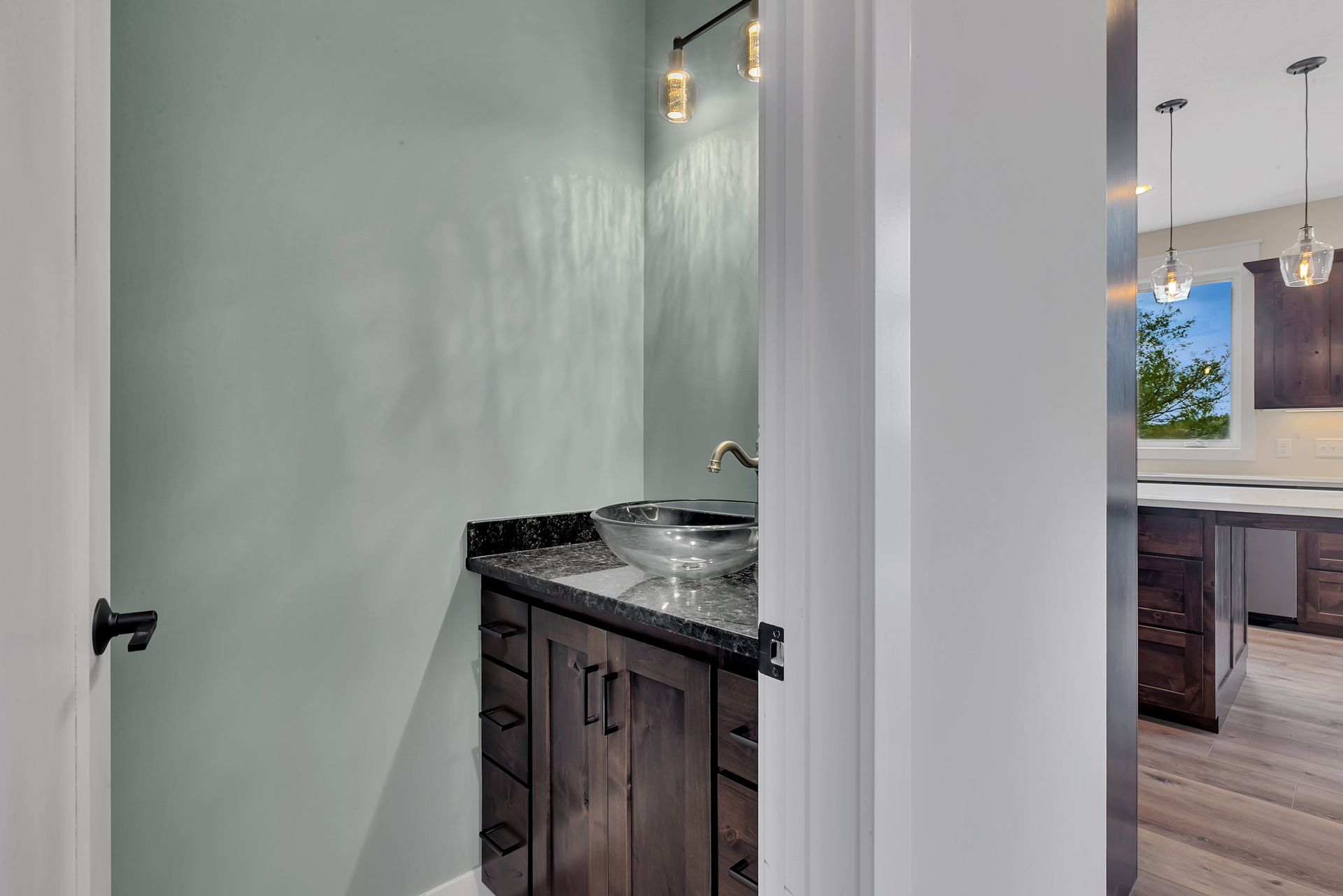 A bathroom with a sink and a mirror in a house.