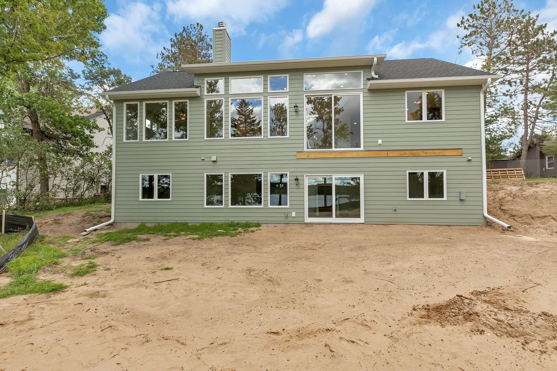 The back of a house with a lot of windows