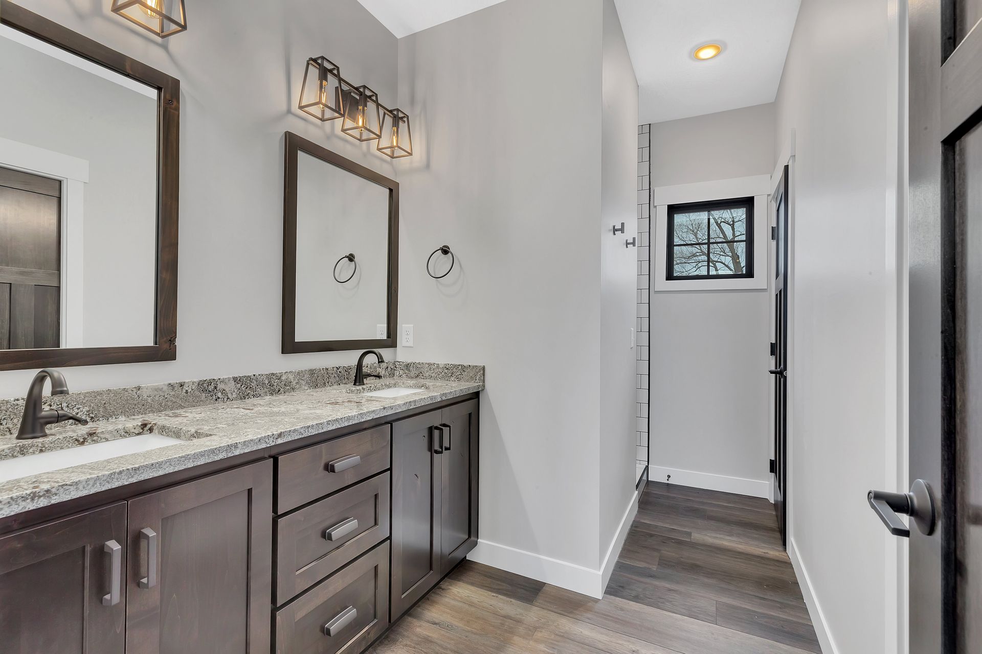 A bathroom with two sinks and two mirrors.