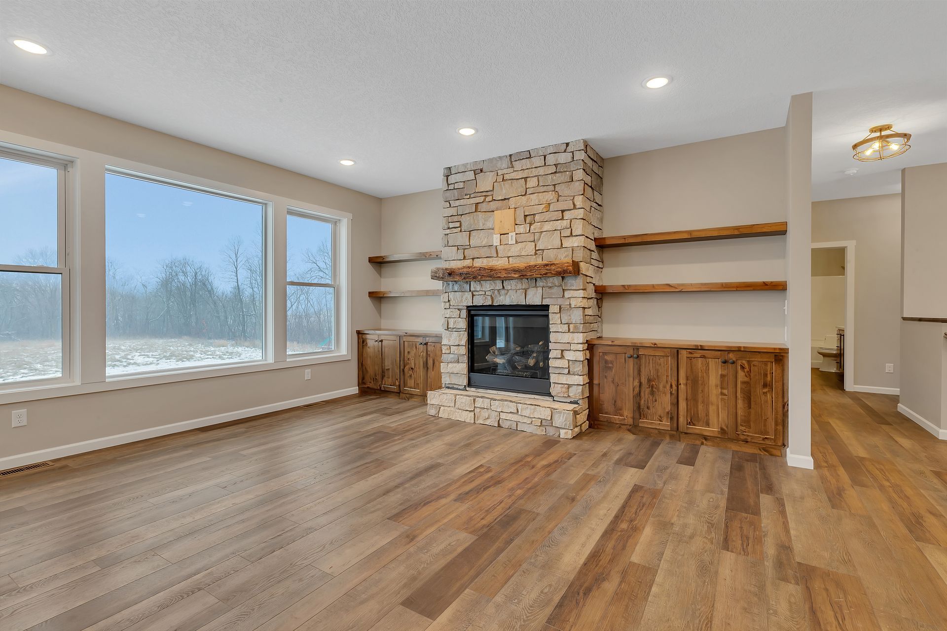 There is a fireplace in the middle of the living room.