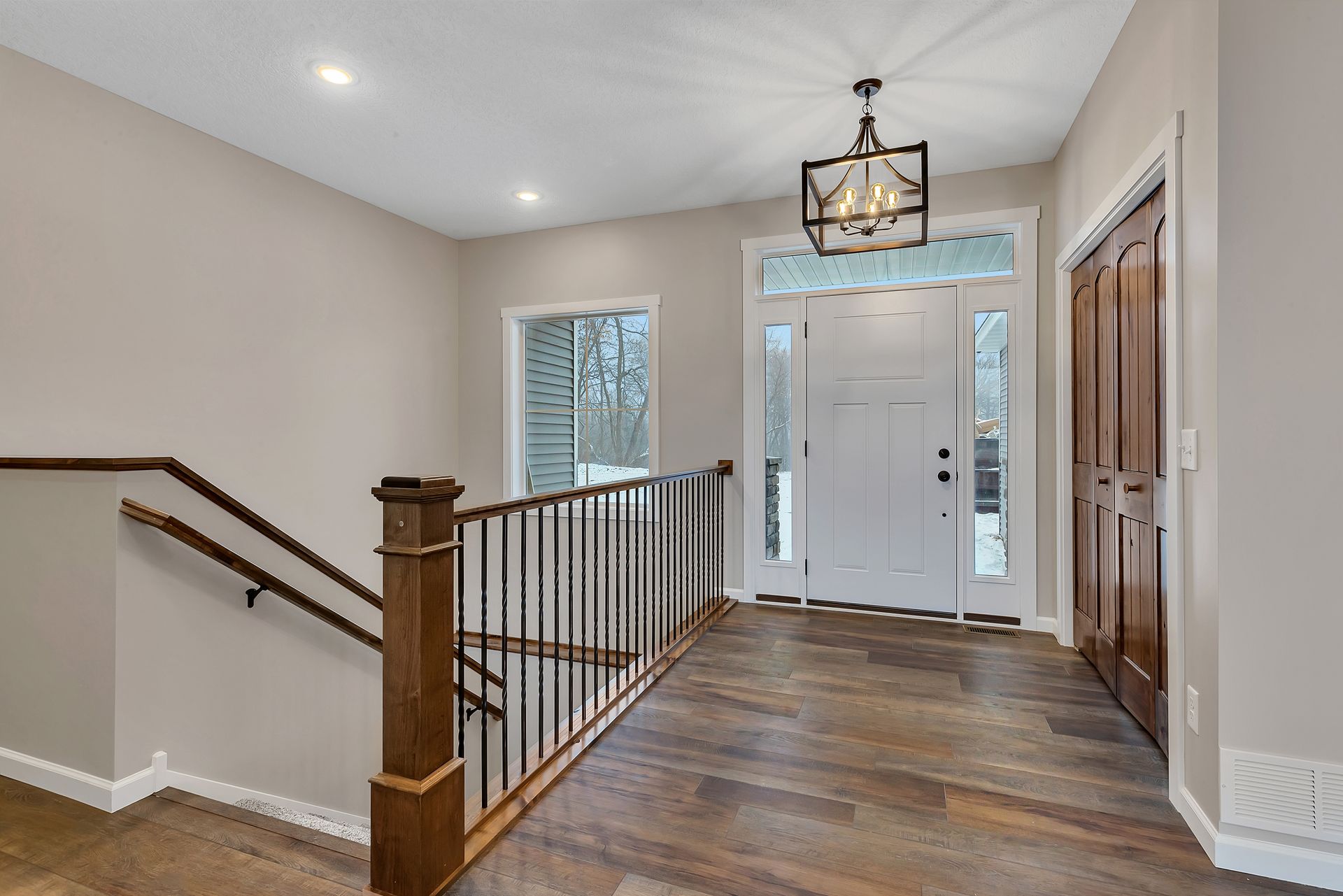 A hallway with stairs leading up to the second floor of a house.