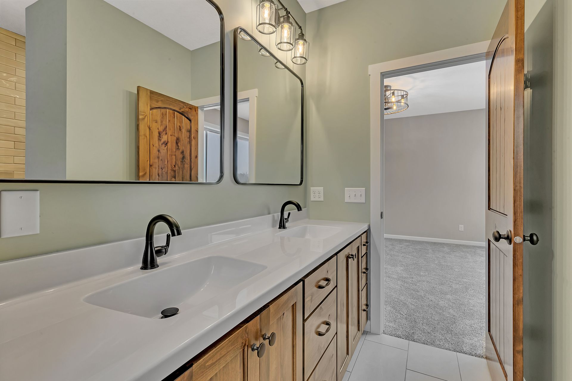 A bathroom with two sinks and two mirrors.