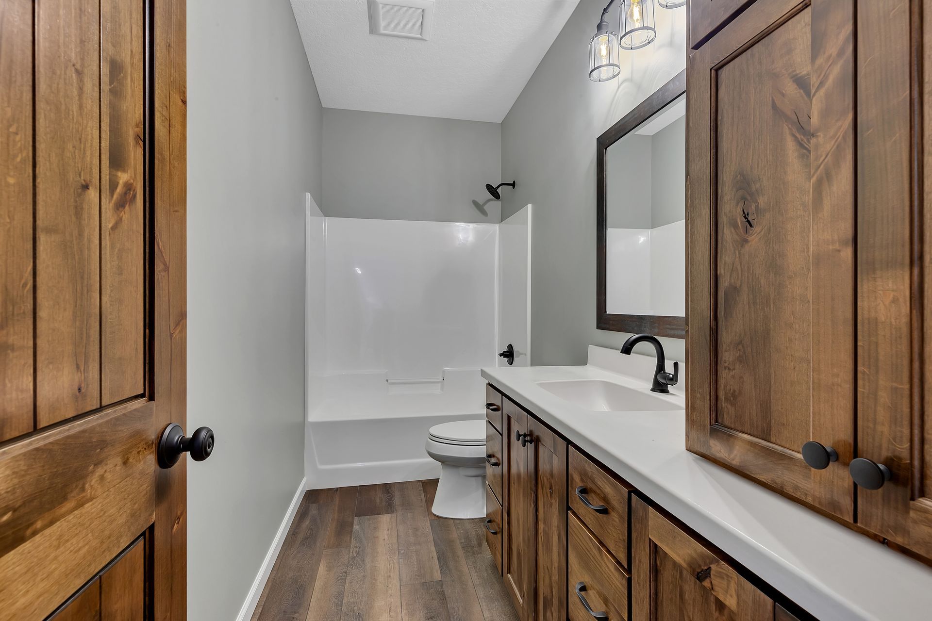 A bathroom with two sinks , a toilet , and a bathtub.