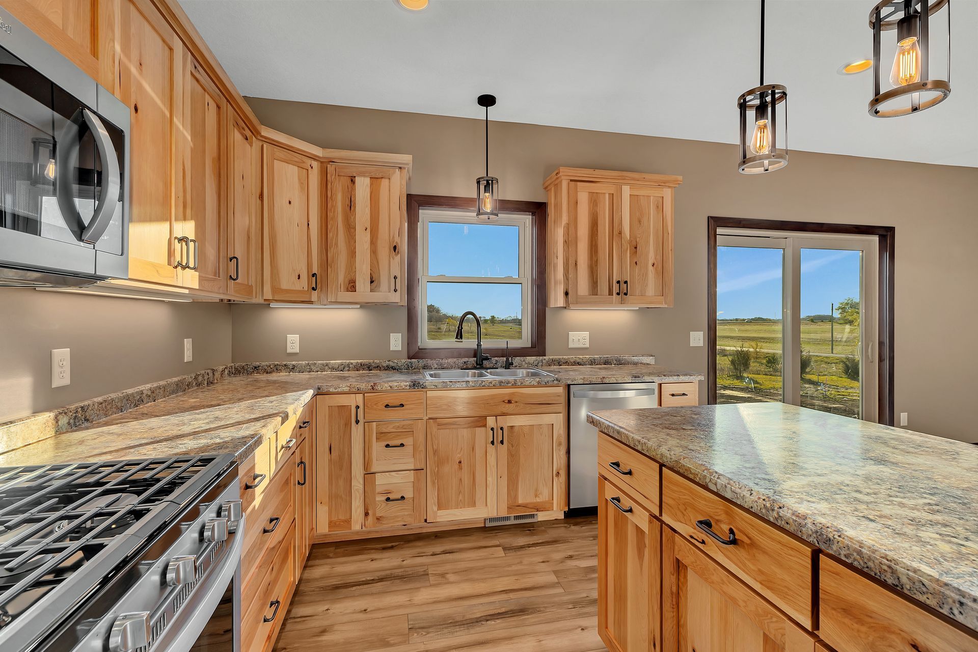 A kitchen with wooden cabinets and granite counter tops.