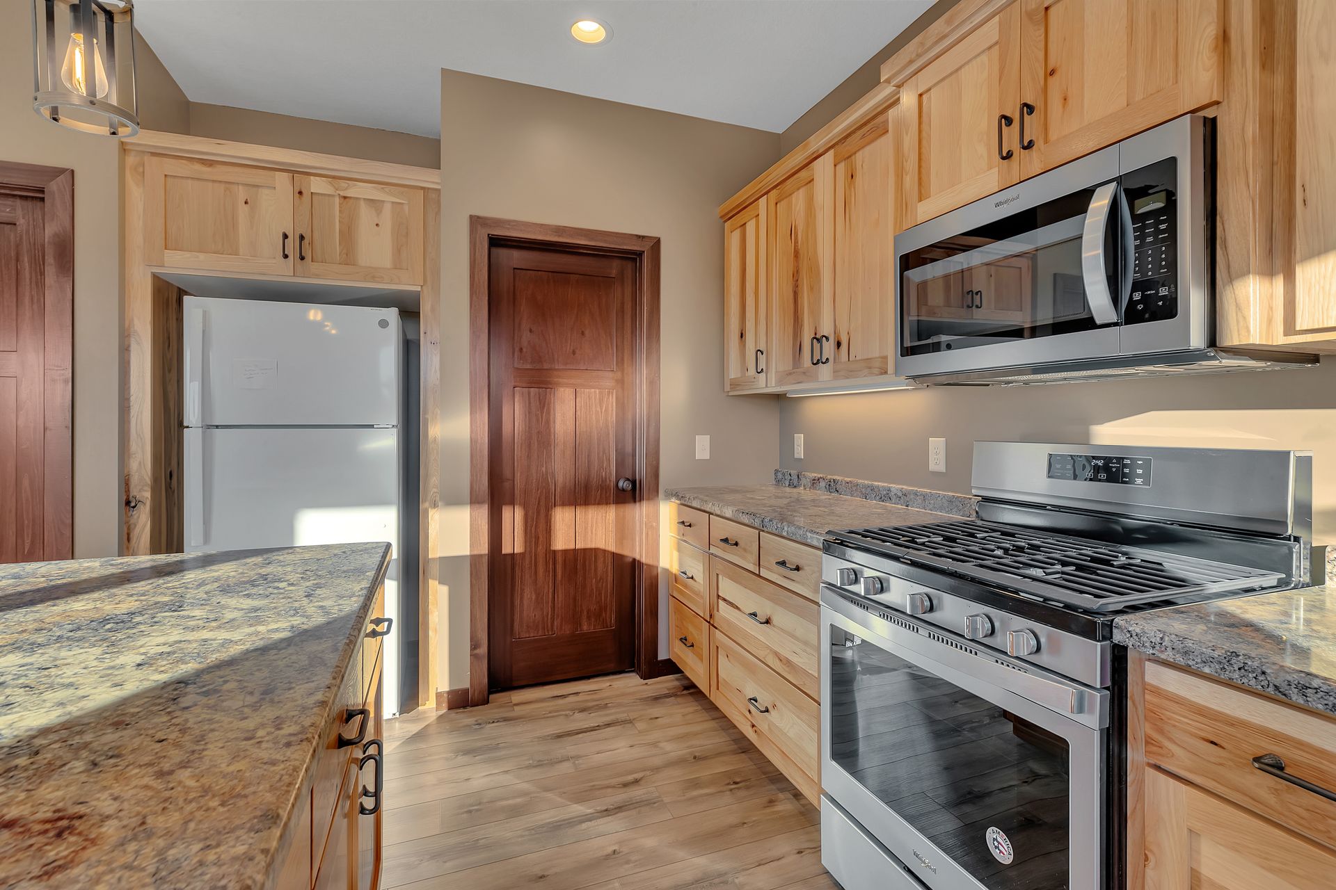 A kitchen with wooden cabinets and stainless steel appliances