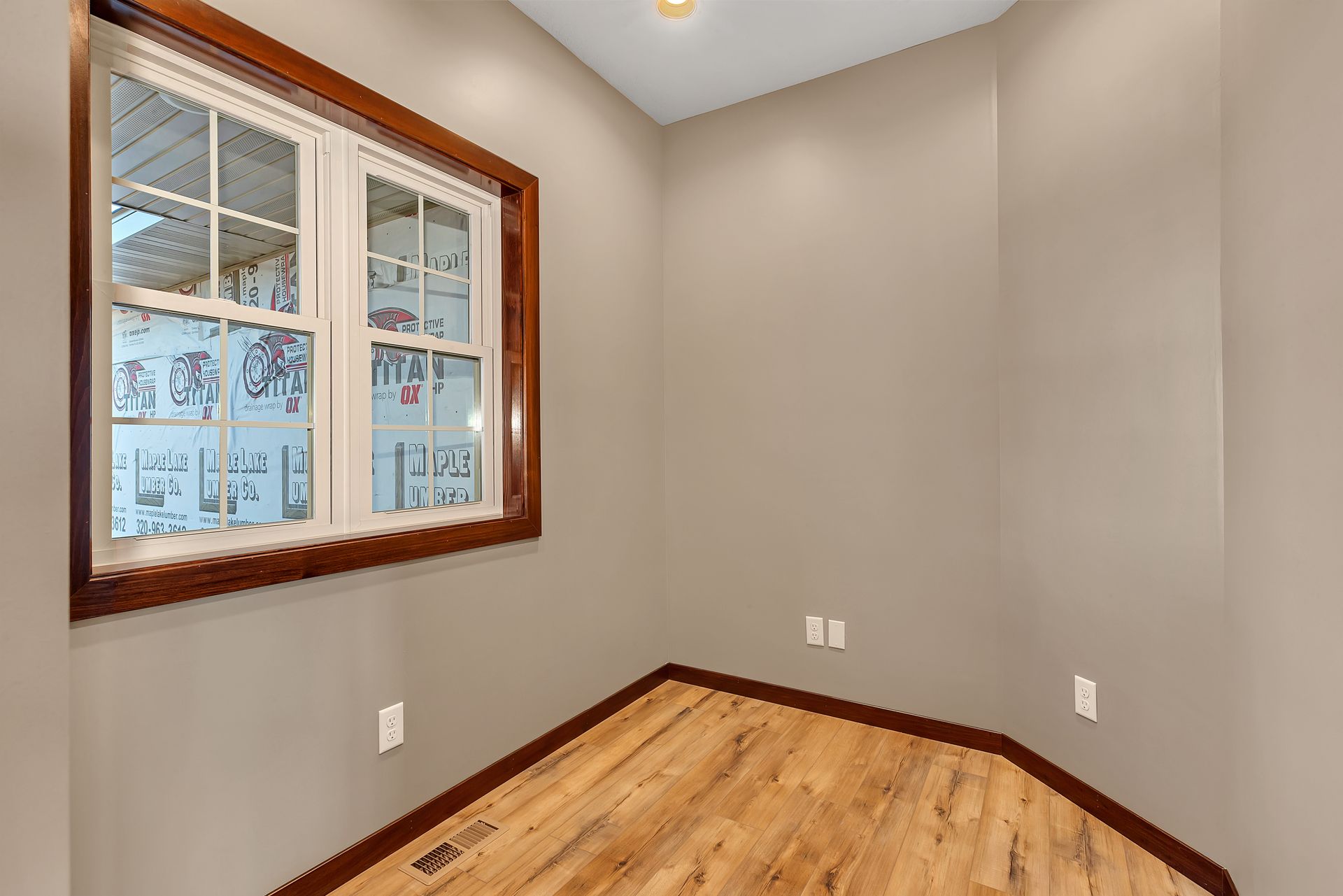 There is a large window in the corner of the room.