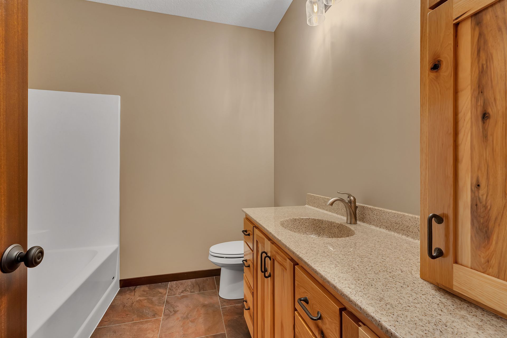 A bathroom with a sink , toilet and shower.