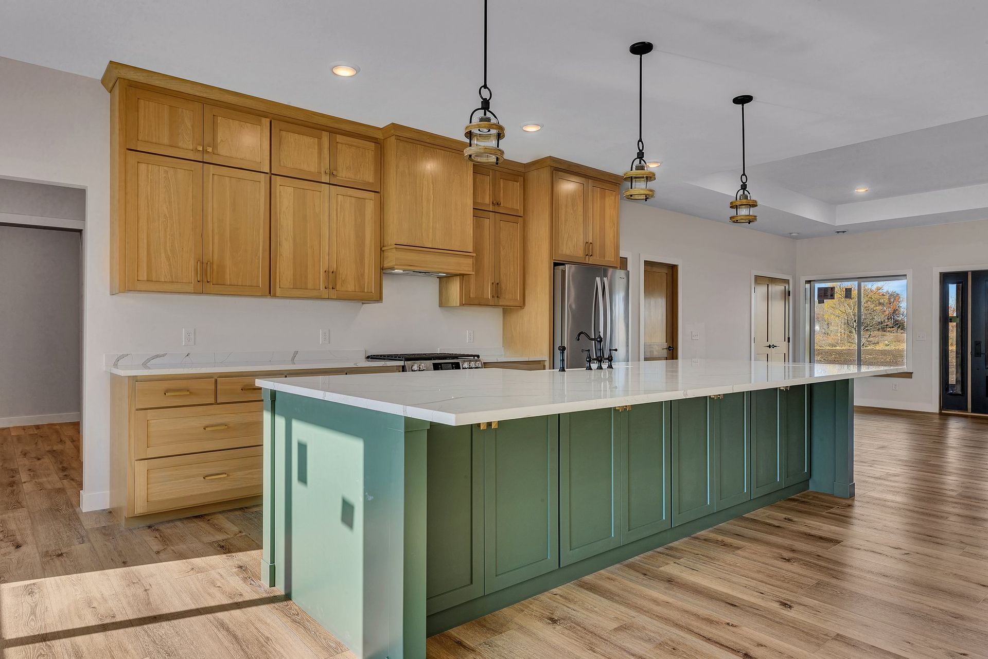 A kitchen with a large island and wooden cabinets