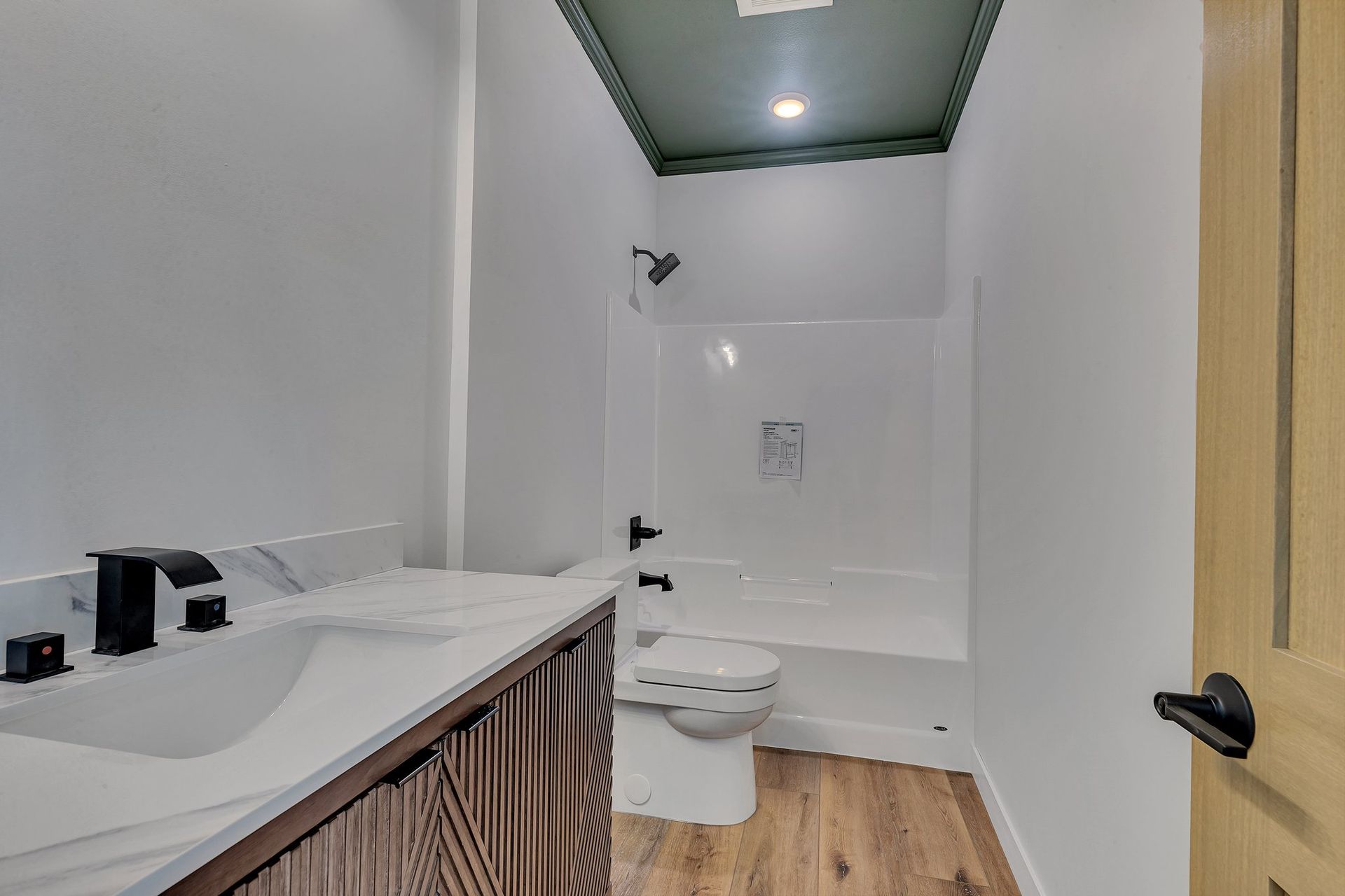 A bathroom with a sink , toilet , bathtub and shower.