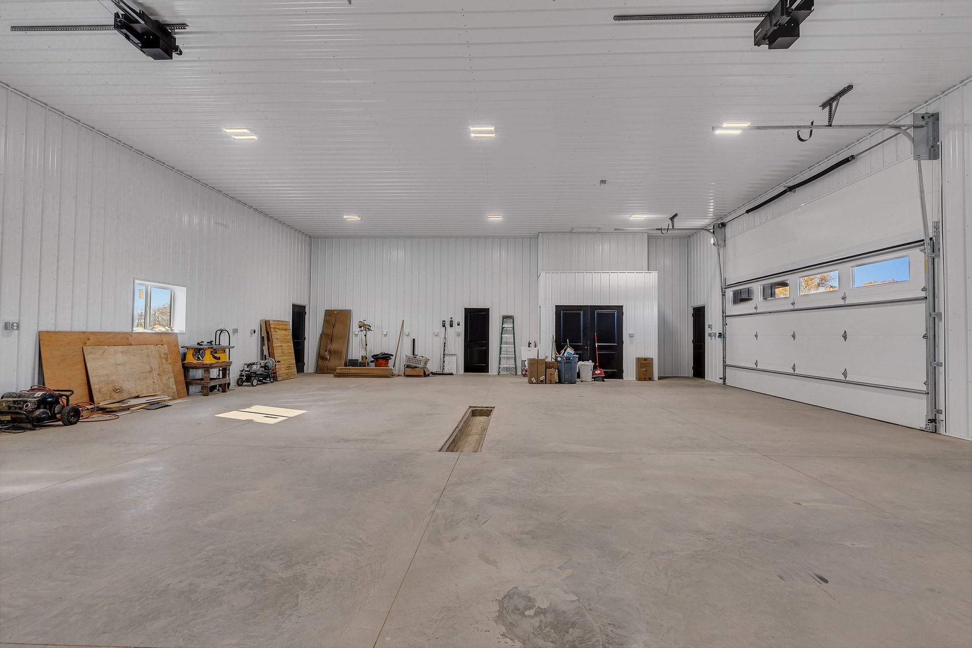 A large empty warehouse with a large garage door.