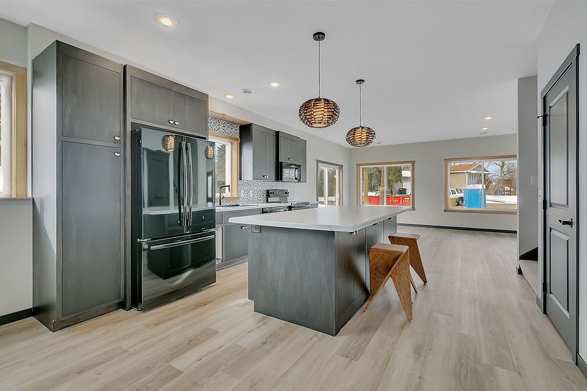 A kitchen with a large island and a refrigerator.