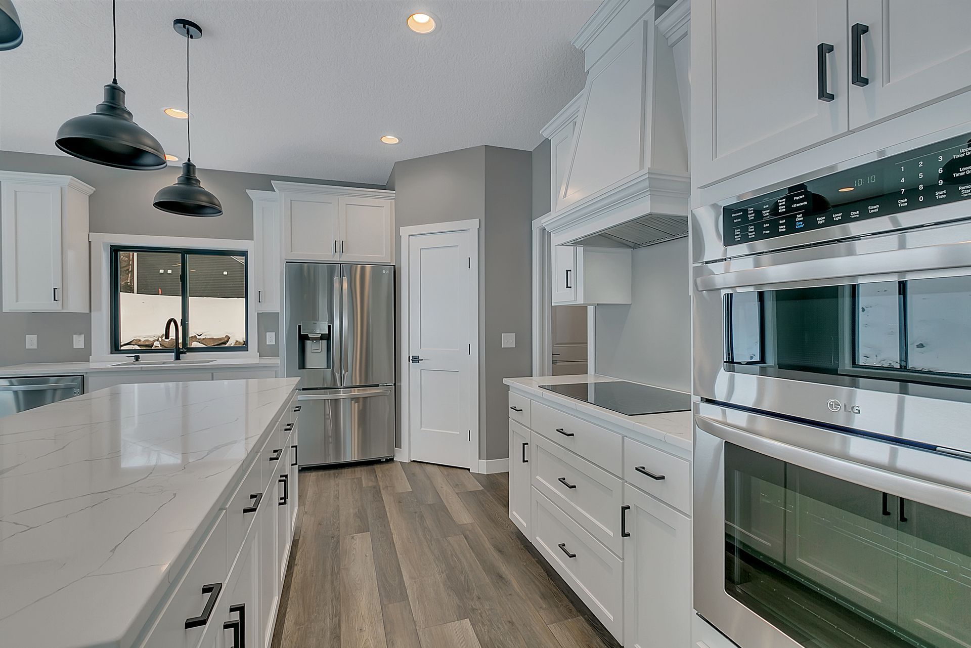 A kitchen with white cabinets and stainless steel appliances.