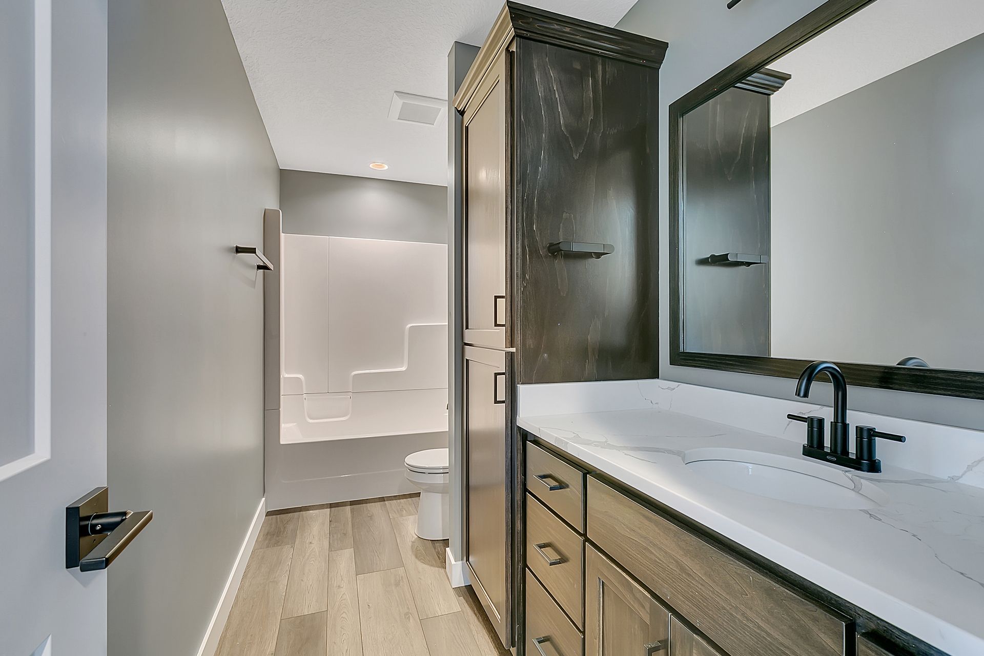 A bathroom with a sink , mirror and toilet.