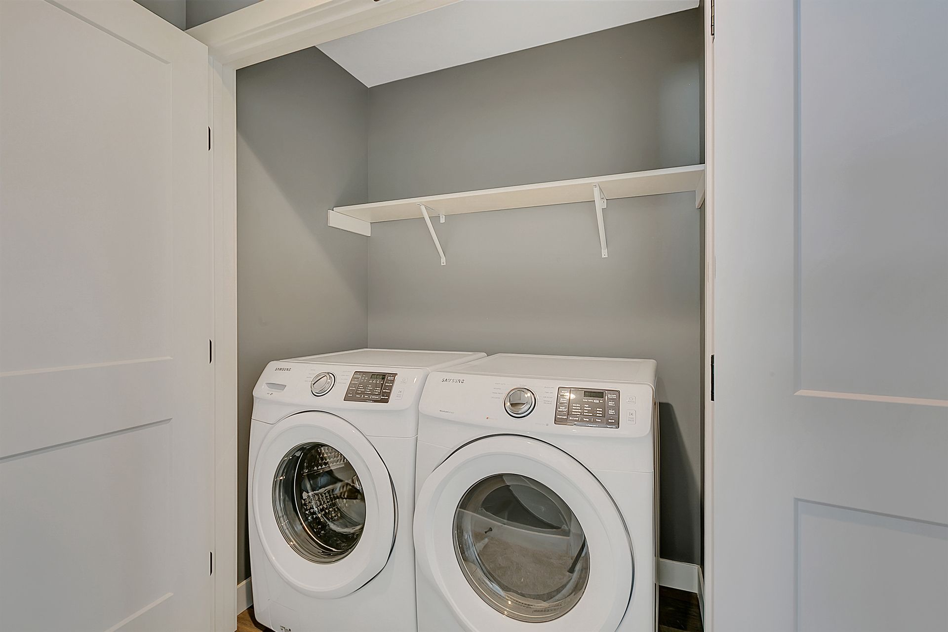 A laundry room with a washer and dryer in it