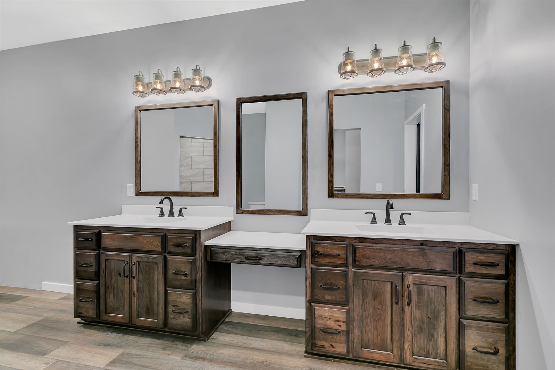 A bathroom with two sinks and two mirrors.