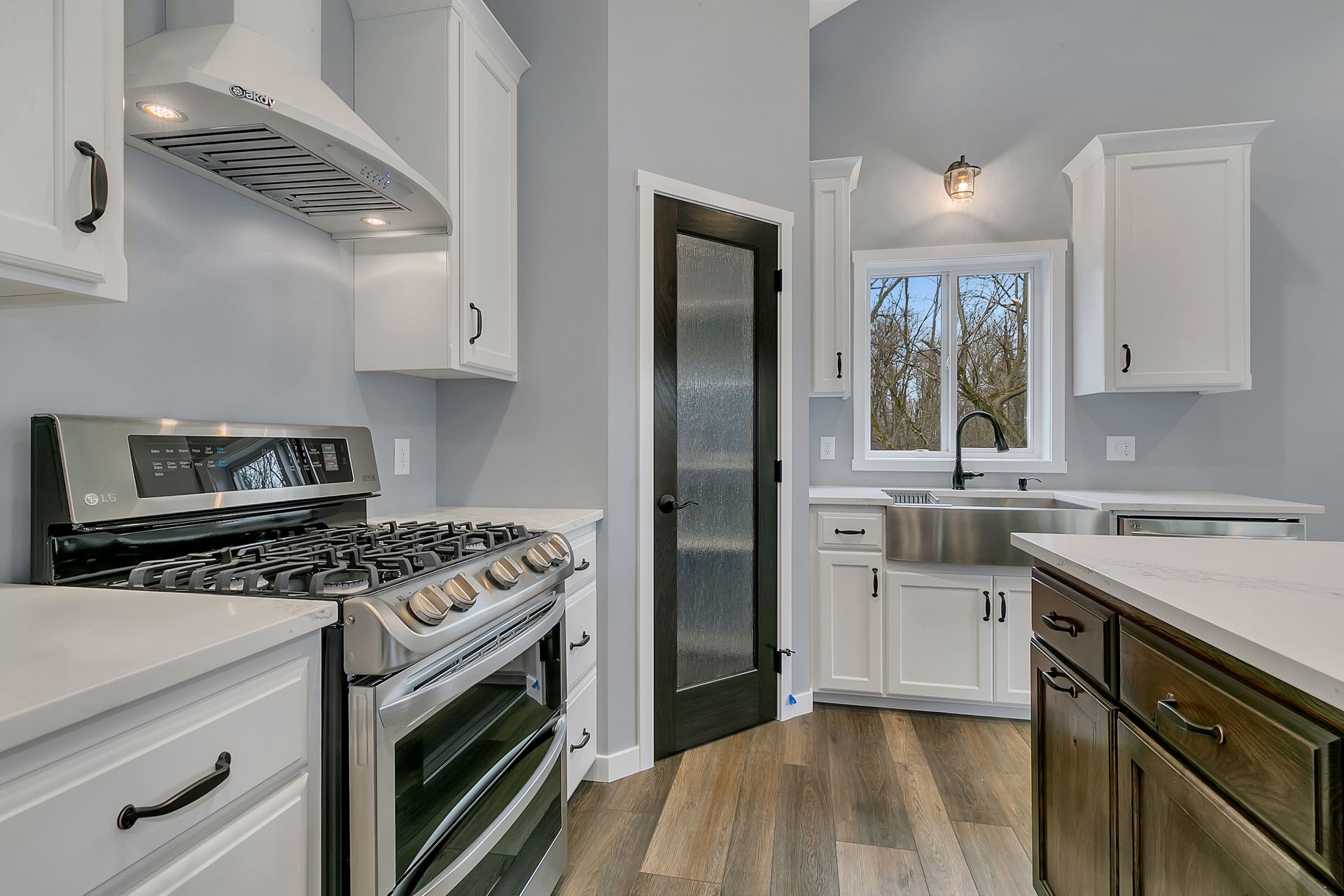 A kitchen with stainless steel appliances and white cabinets