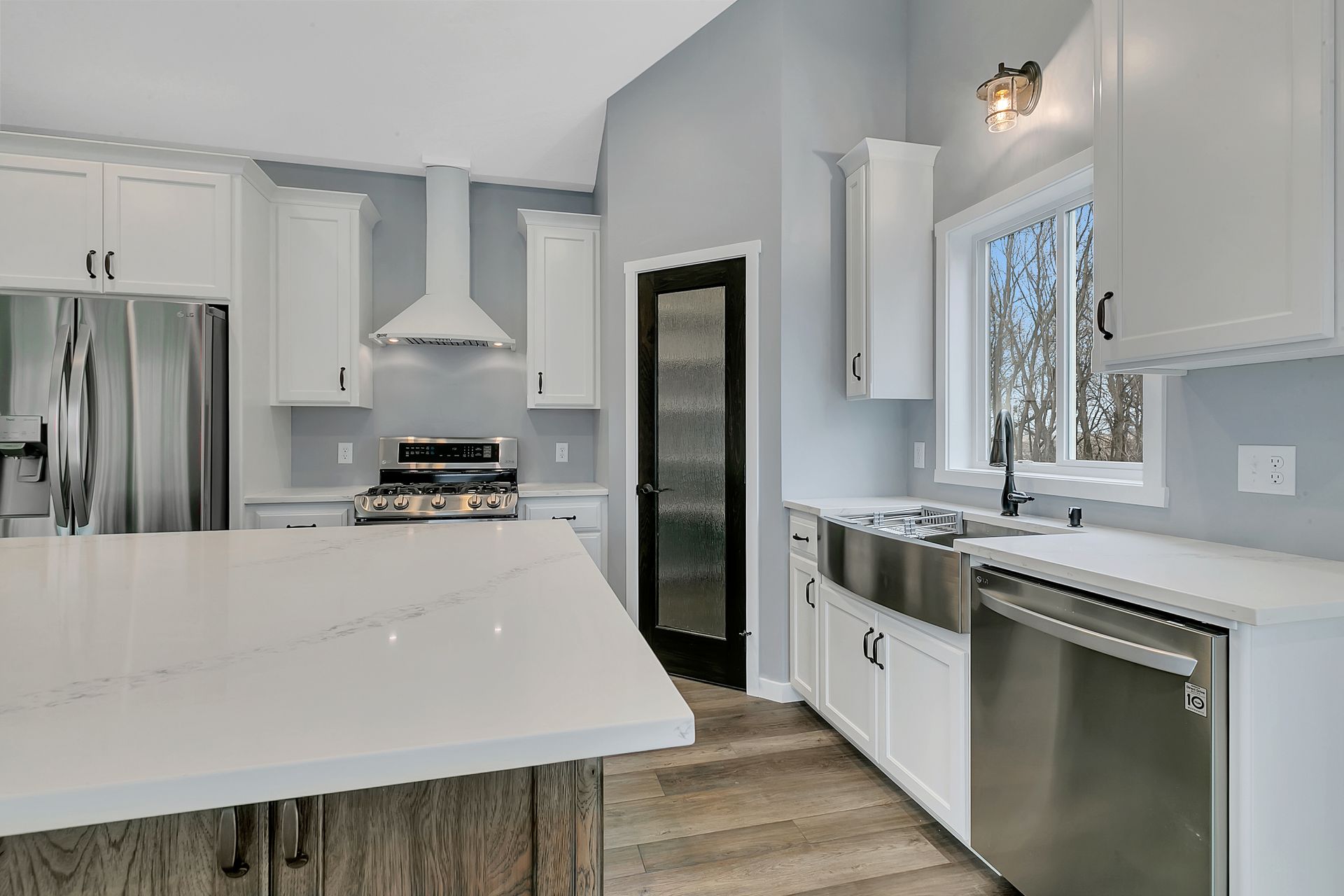 A kitchen with white cabinets and stainless steel appliances.