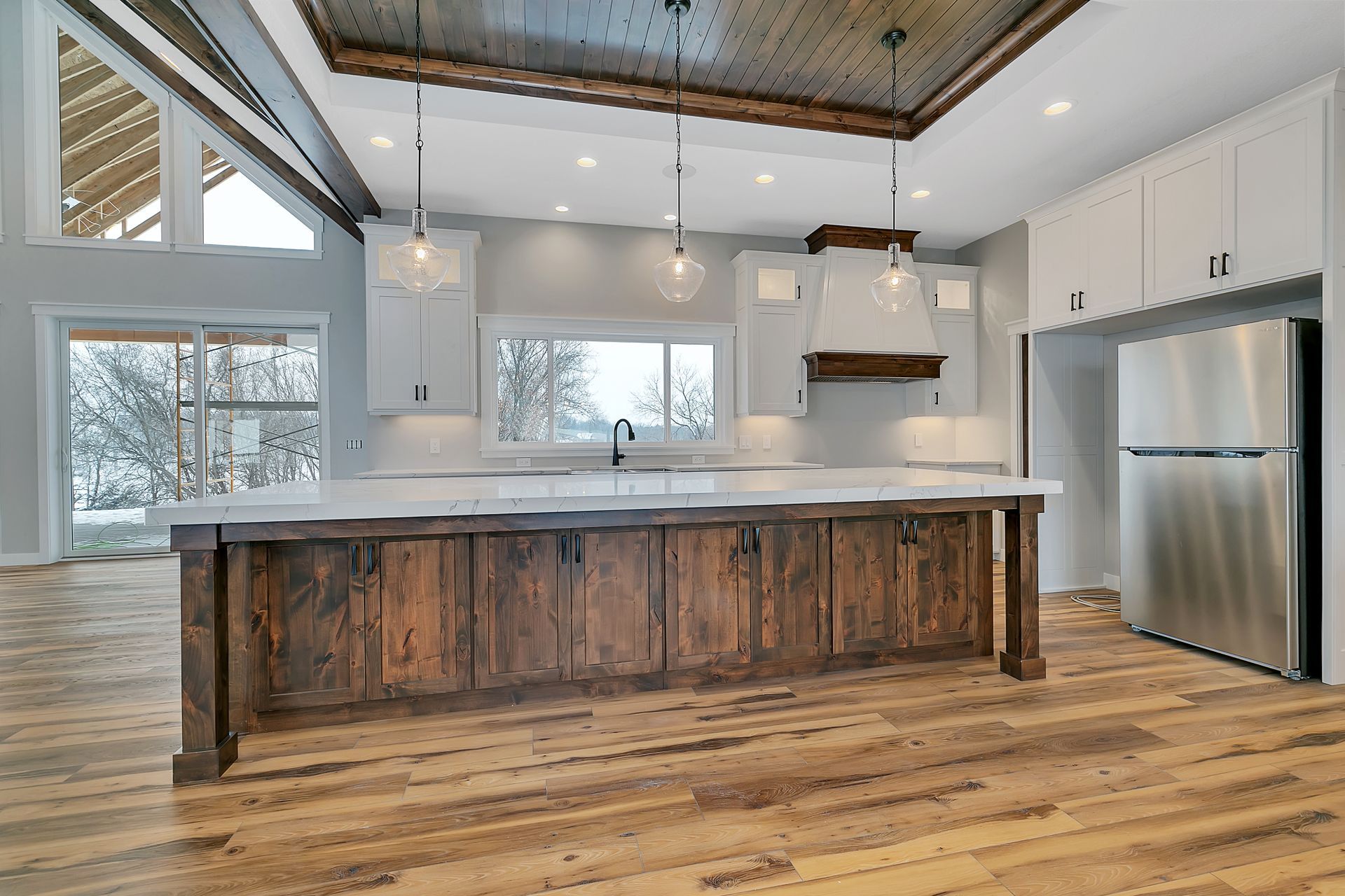 A kitchen with a large island and stainless steel appliances.