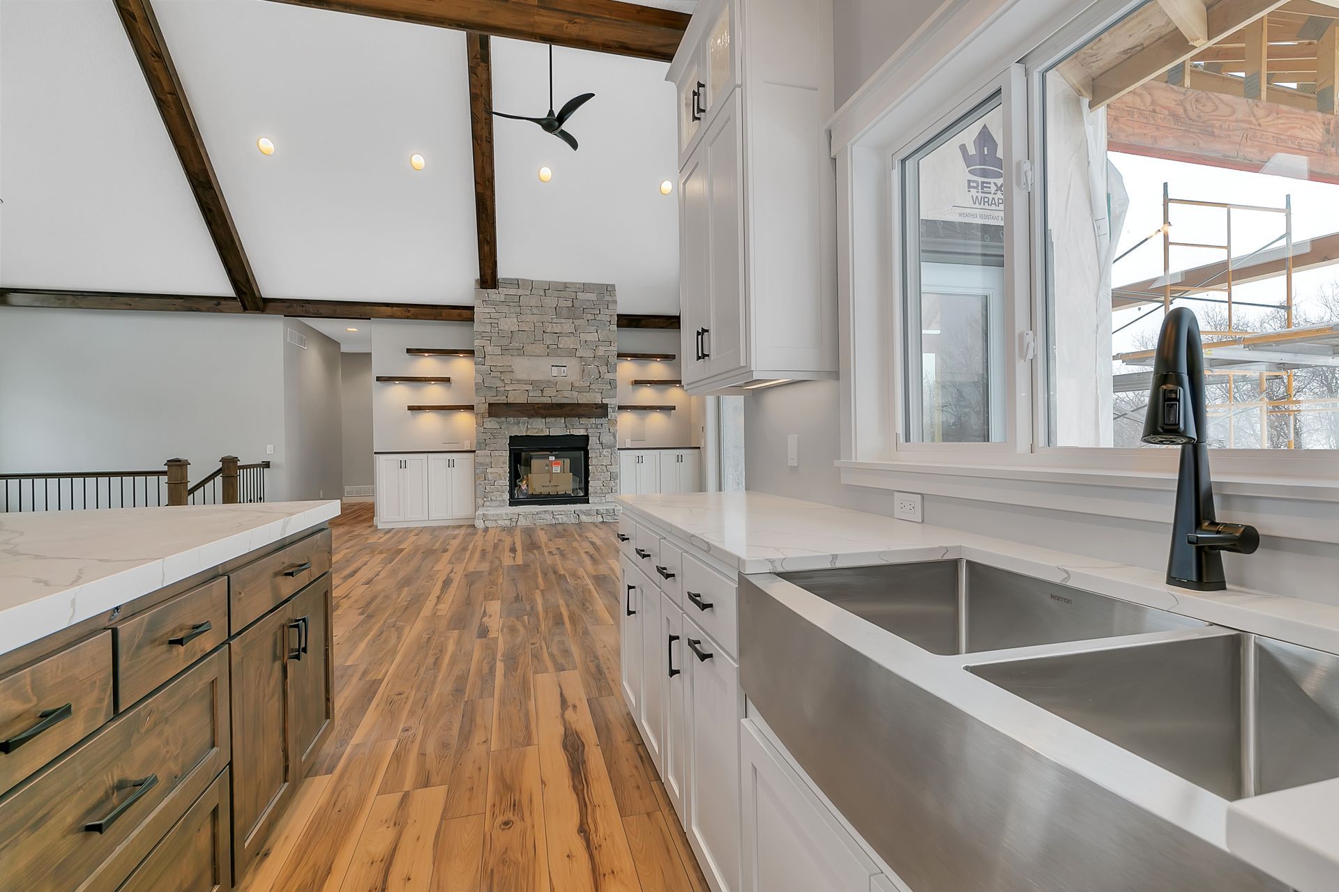A kitchen with two sinks and a fireplace.