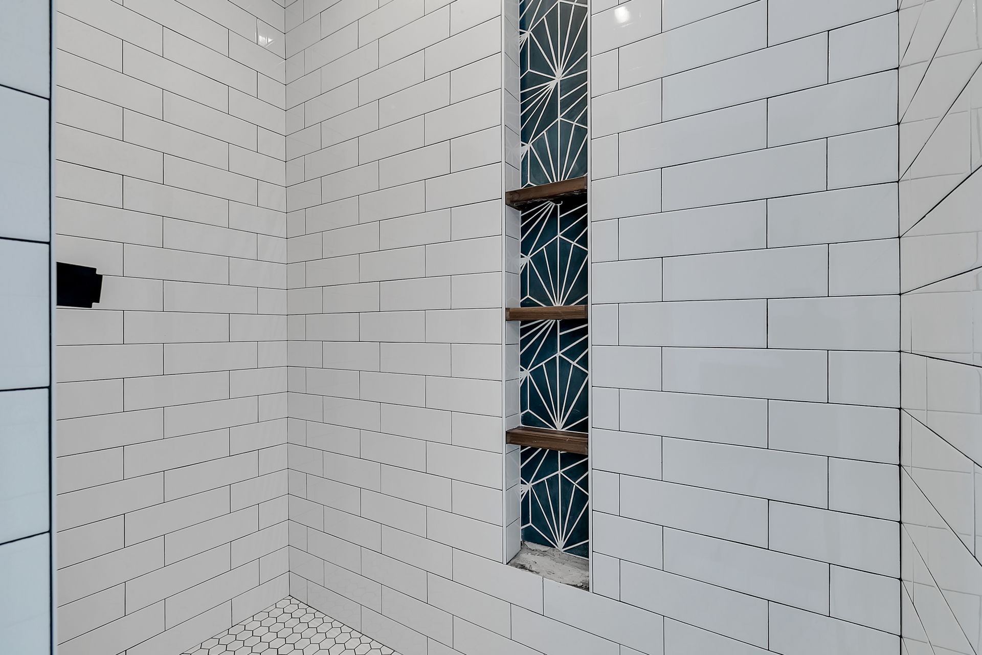 A bathroom with white tiles and a window
