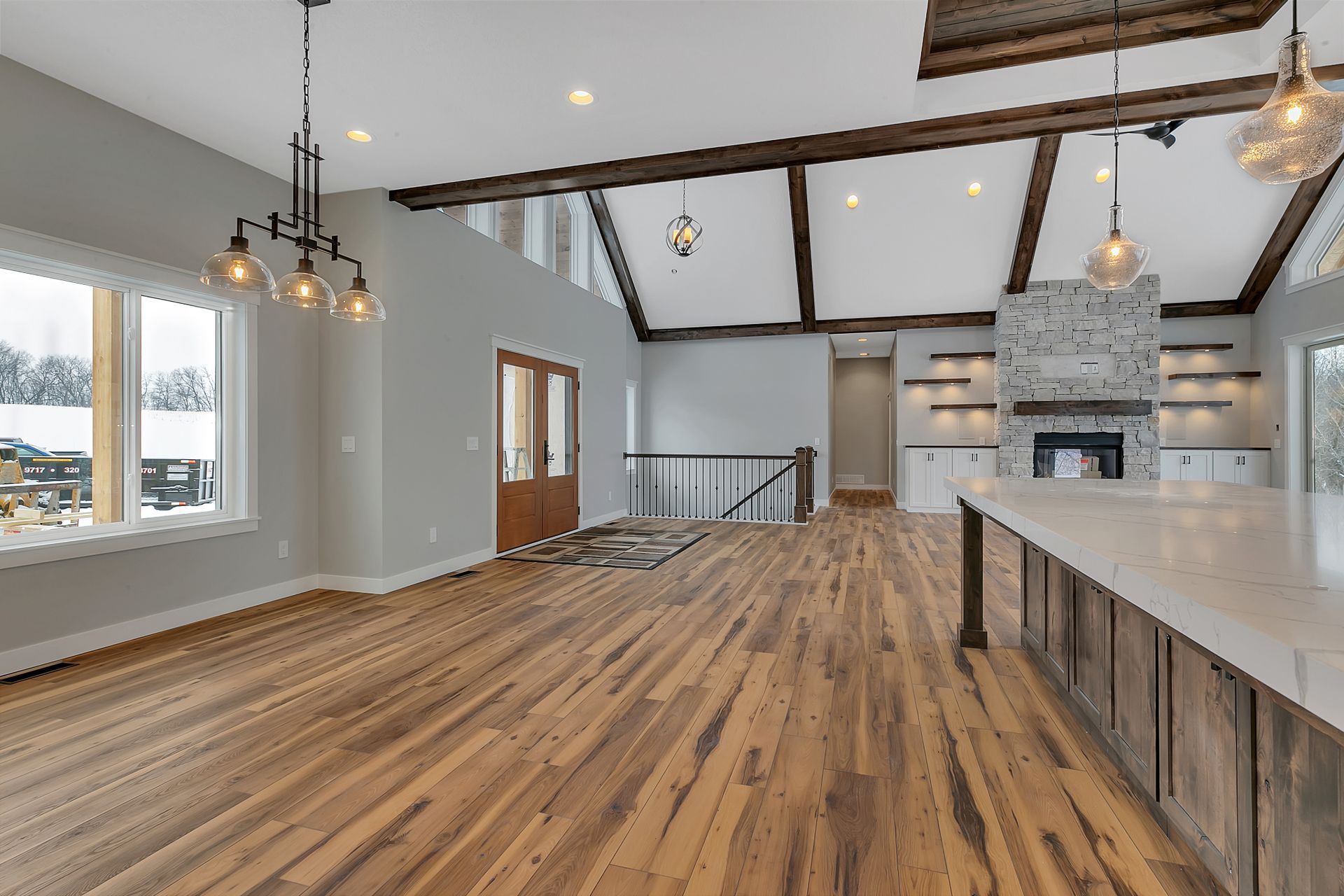 A large empty room with hardwood floors and a fireplace.