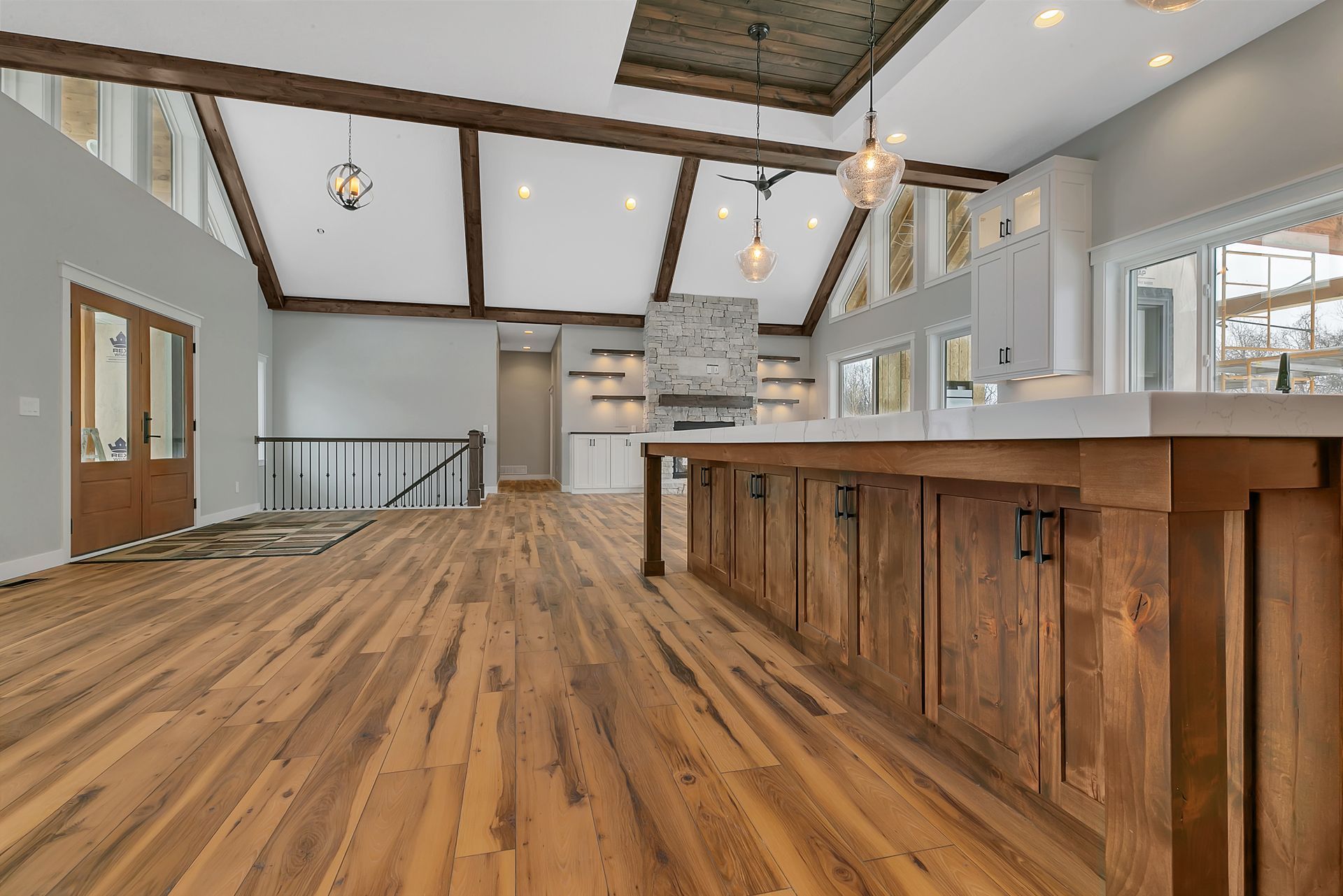 A kitchen with hardwood floors and a large island.