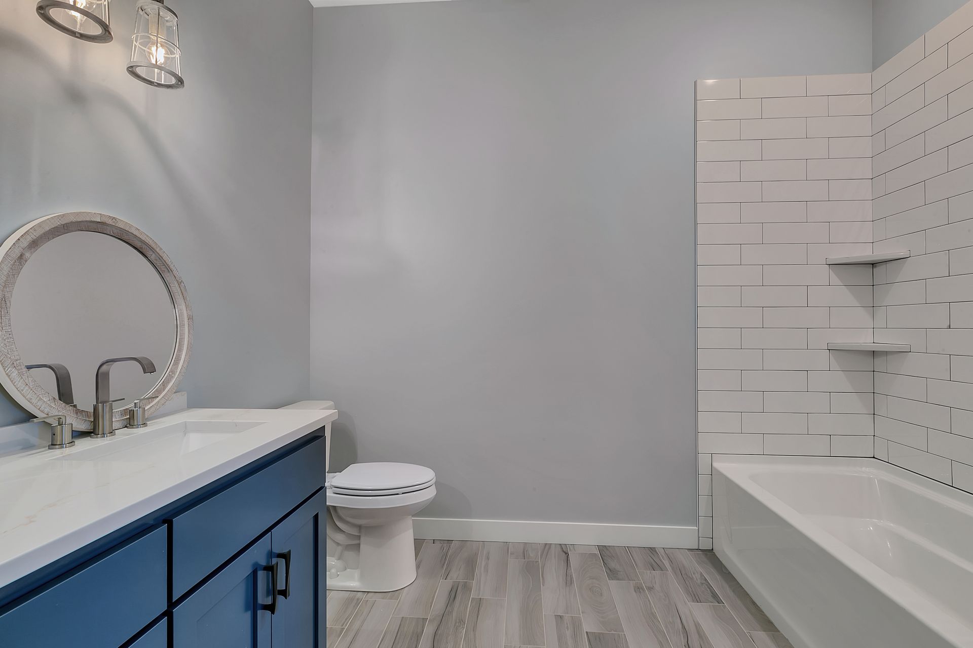 A bathroom with a toilet , sink , and bathtub.