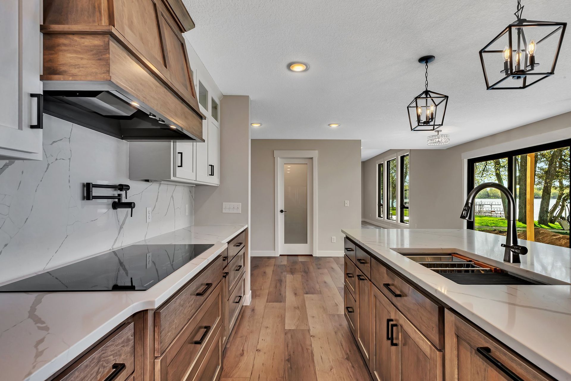 A kitchen with wooden cabinets , white counter tops , a sink , and a stove top oven.