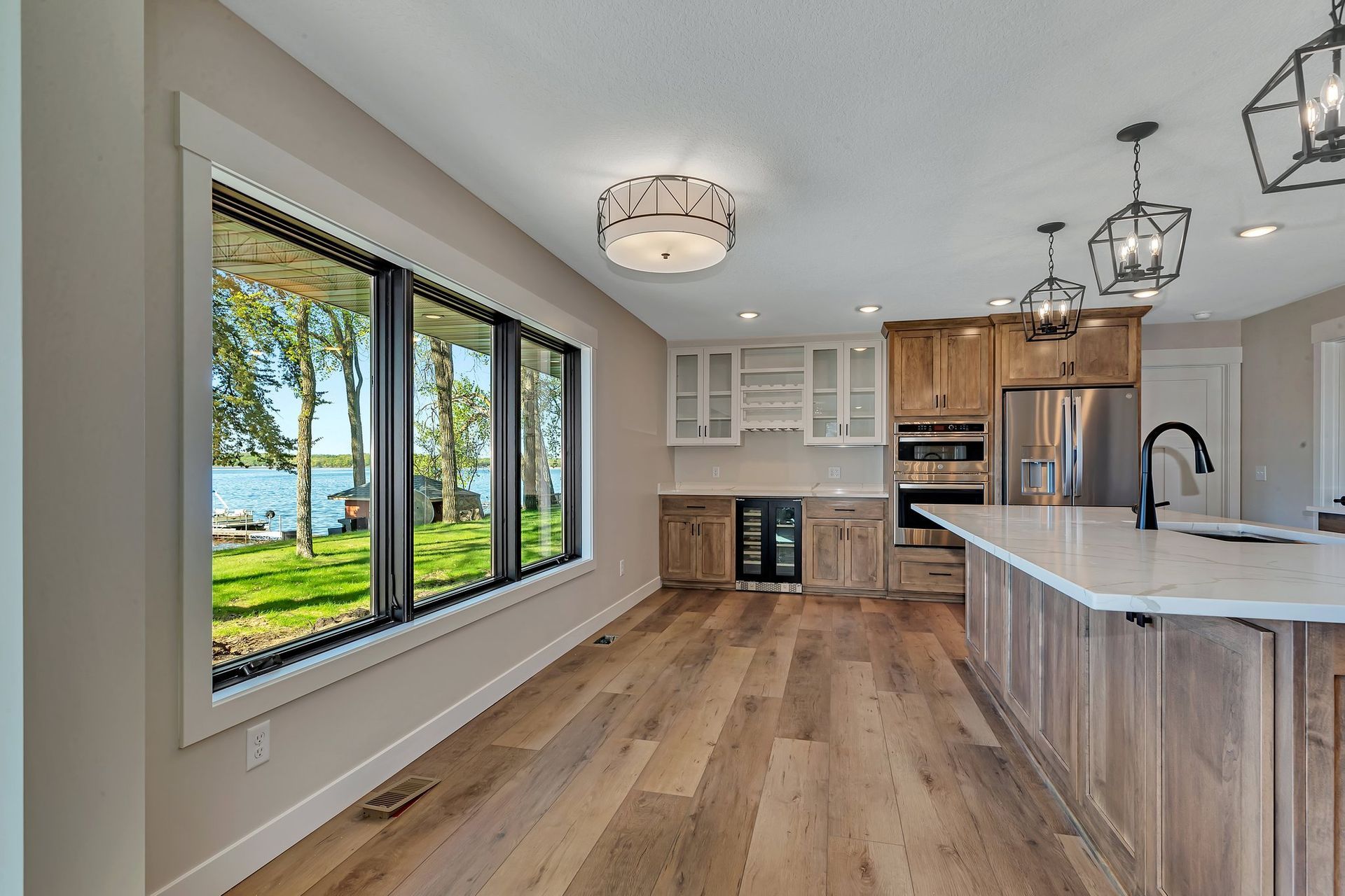A kitchen with a large island and a lot of windows.