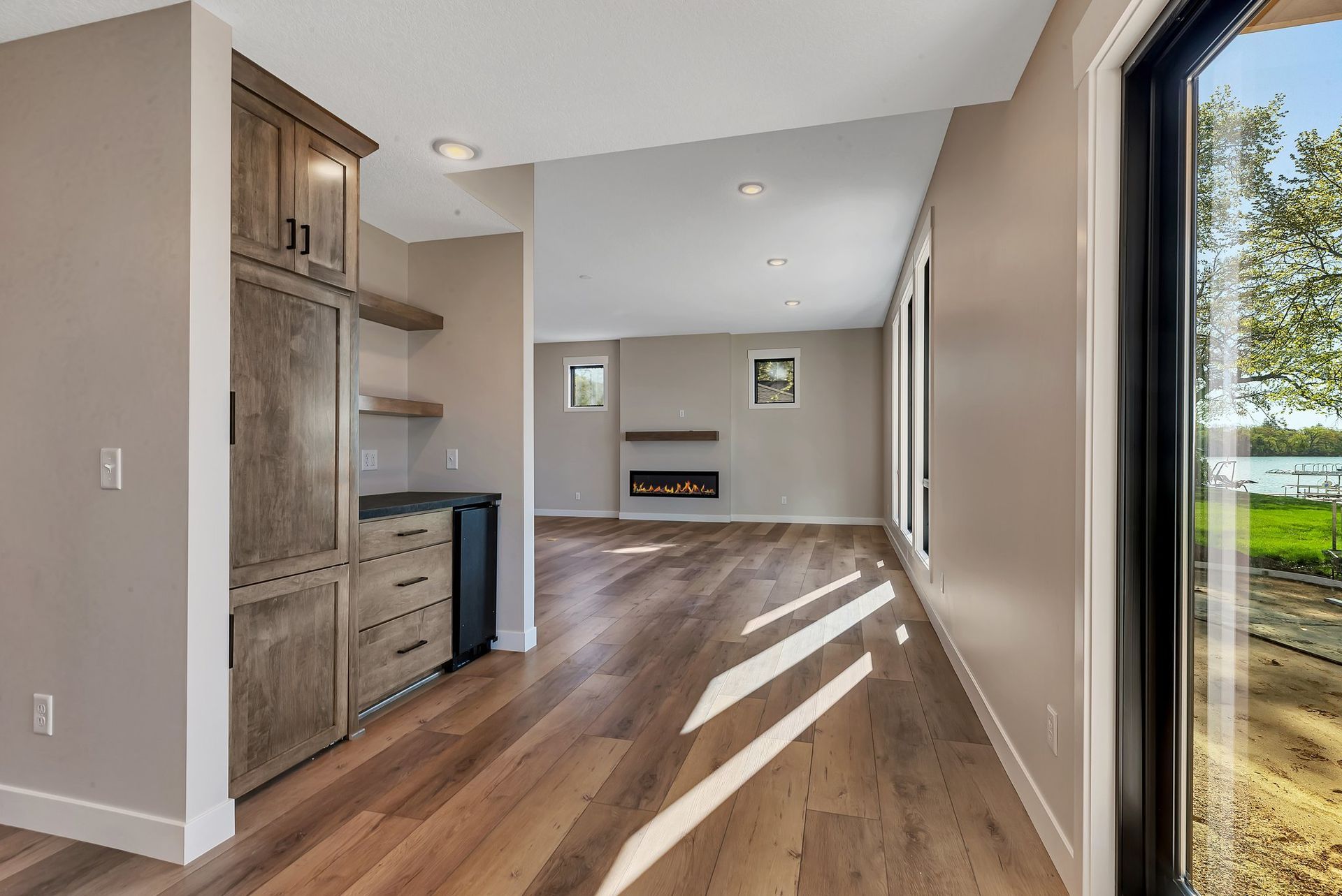 A living room with hardwood floors and a fireplace.