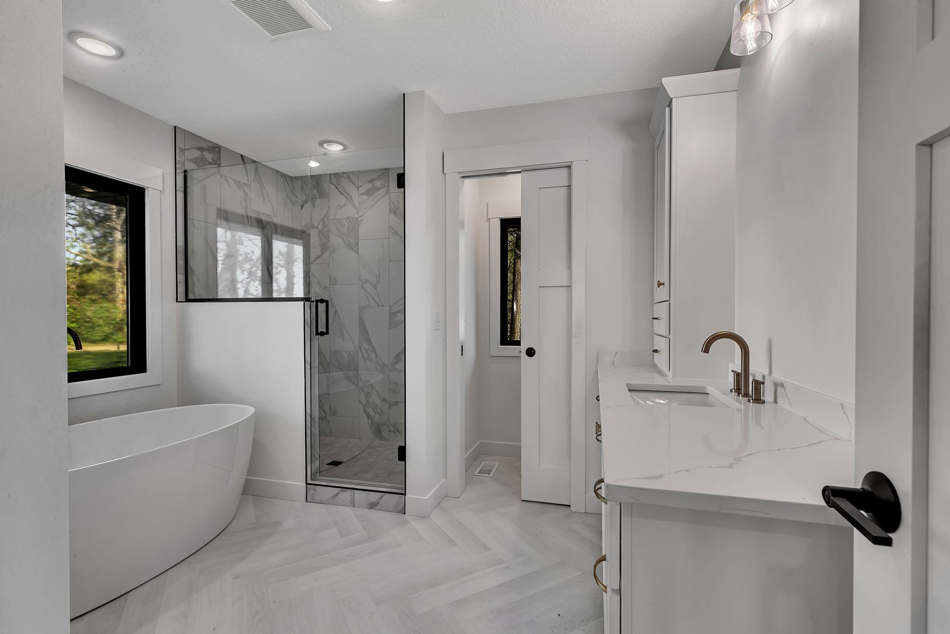 A bathroom with a tub , sink , and shower.