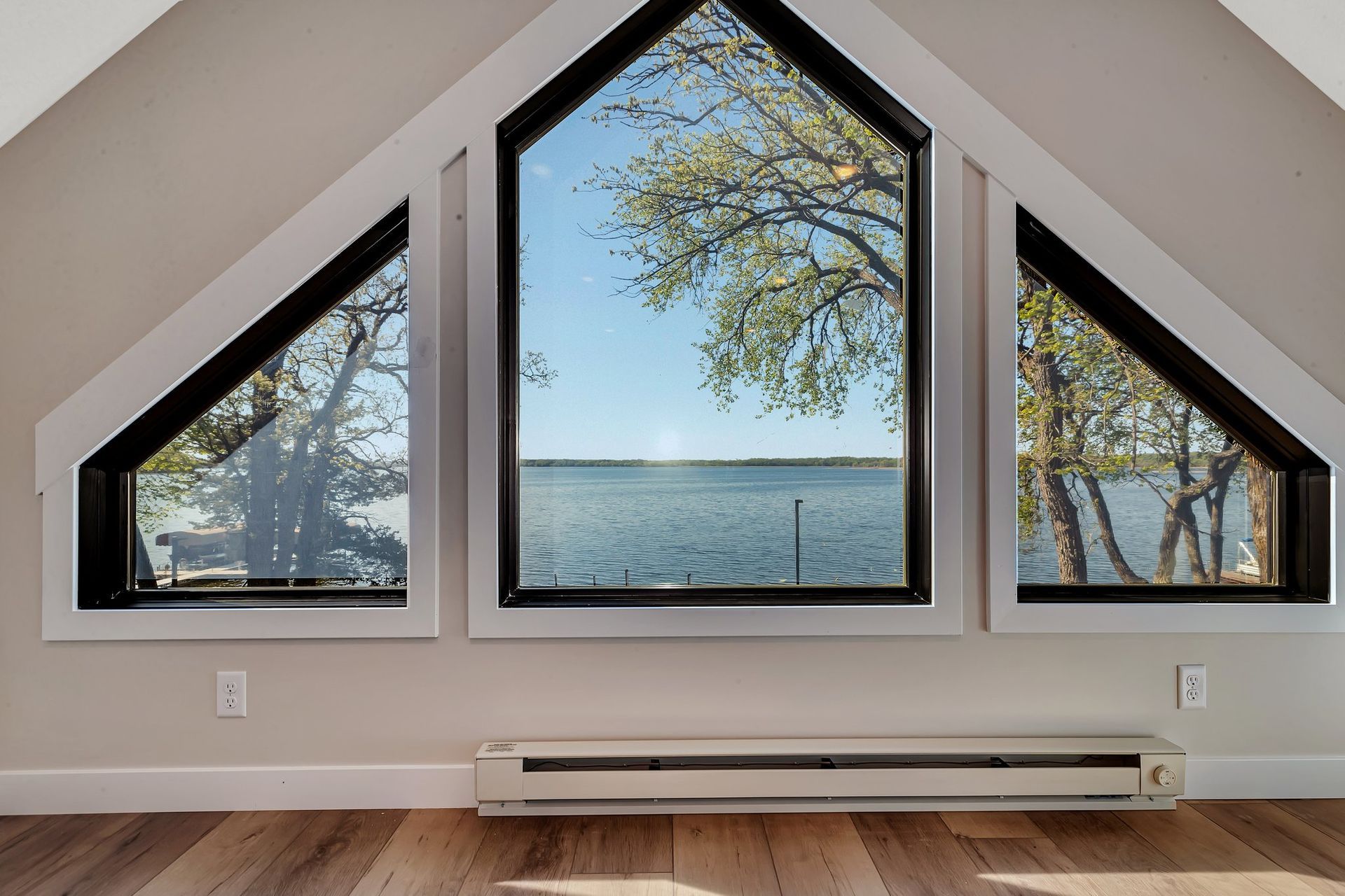 A large window with a view of a lake and trees