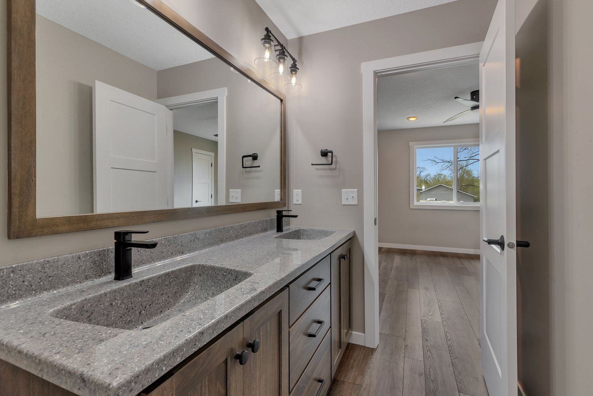 A bathroom with two sinks and a large mirror.