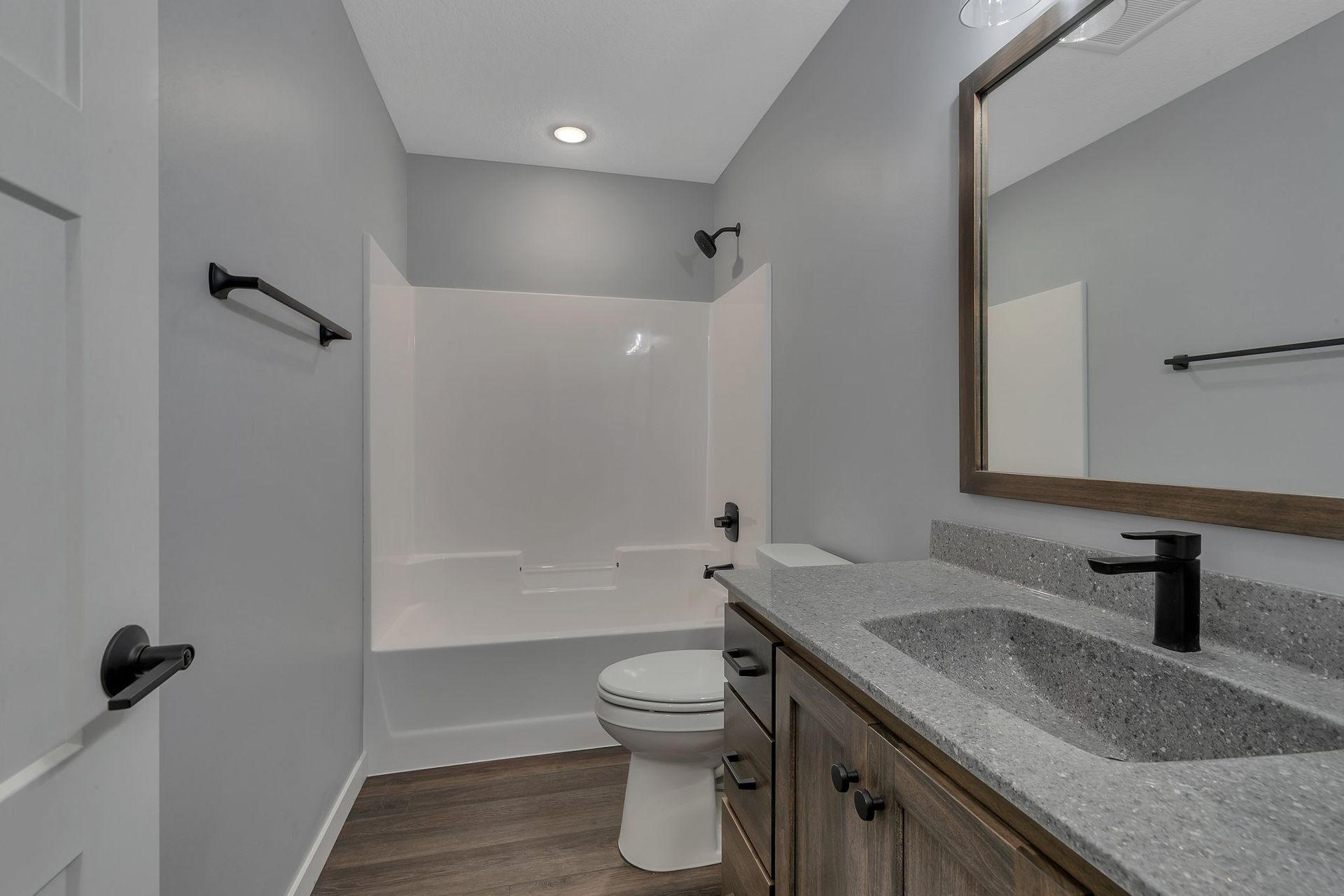 A bathroom with a toilet , sink , and bathtub.