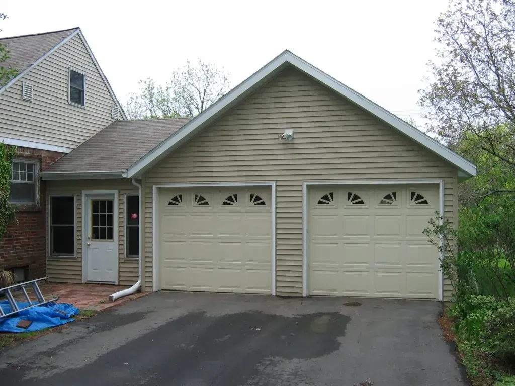 A house with three garage doors and a driveway
