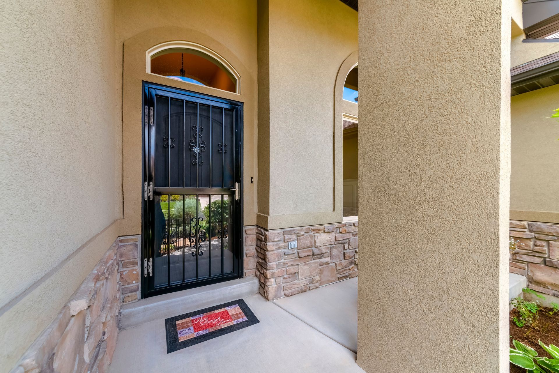 The front door of a house with a welcome mat in front of it