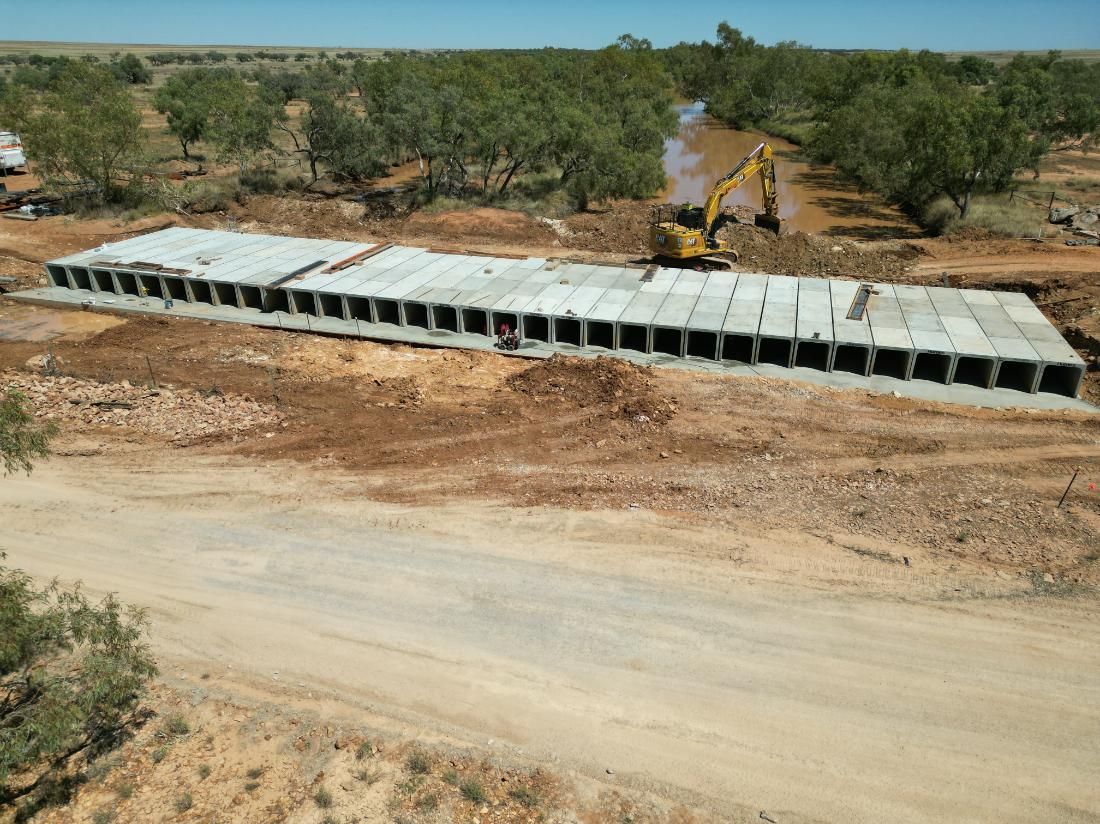 An Aerial View of a Construction Site With a Yellow Excavator — Lohman Contracting in Emerald, QLD