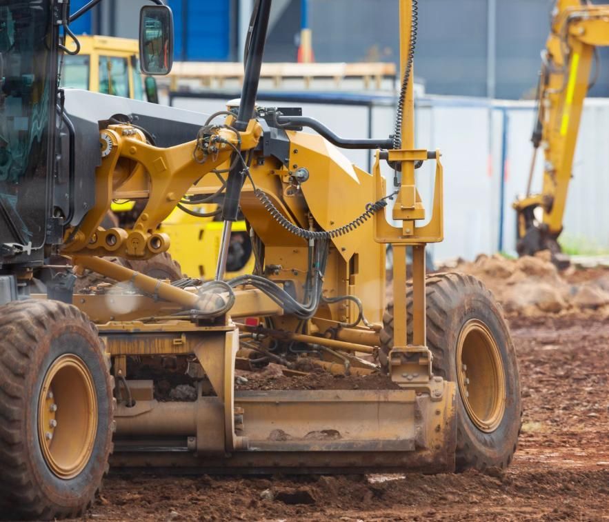 A Bulldozer is Moving Dirt on a Construction Site — Lohman Contracting in Emerald, QLD