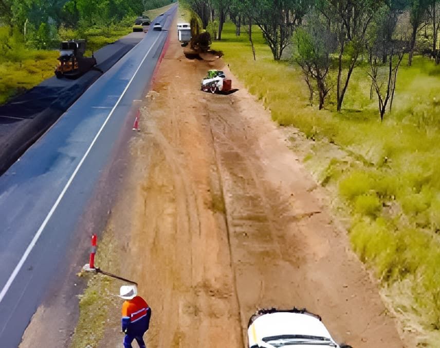 An Aerial View of a Truck Being Towed Down a Dirt Road — Lohman Contracting in Emerald, QLD