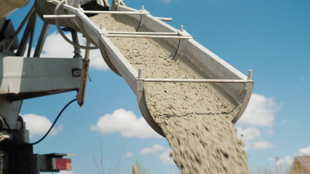 Cement Pours From a Concrete Mixer Truck Chute — Lohman Contracting in Emerald, QLD