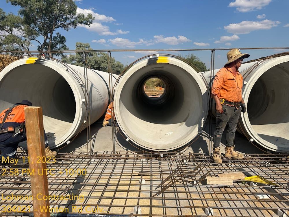 Construction Workers Are Working On Concrete Pipes — Lohman Contracting in Emerald, QLD