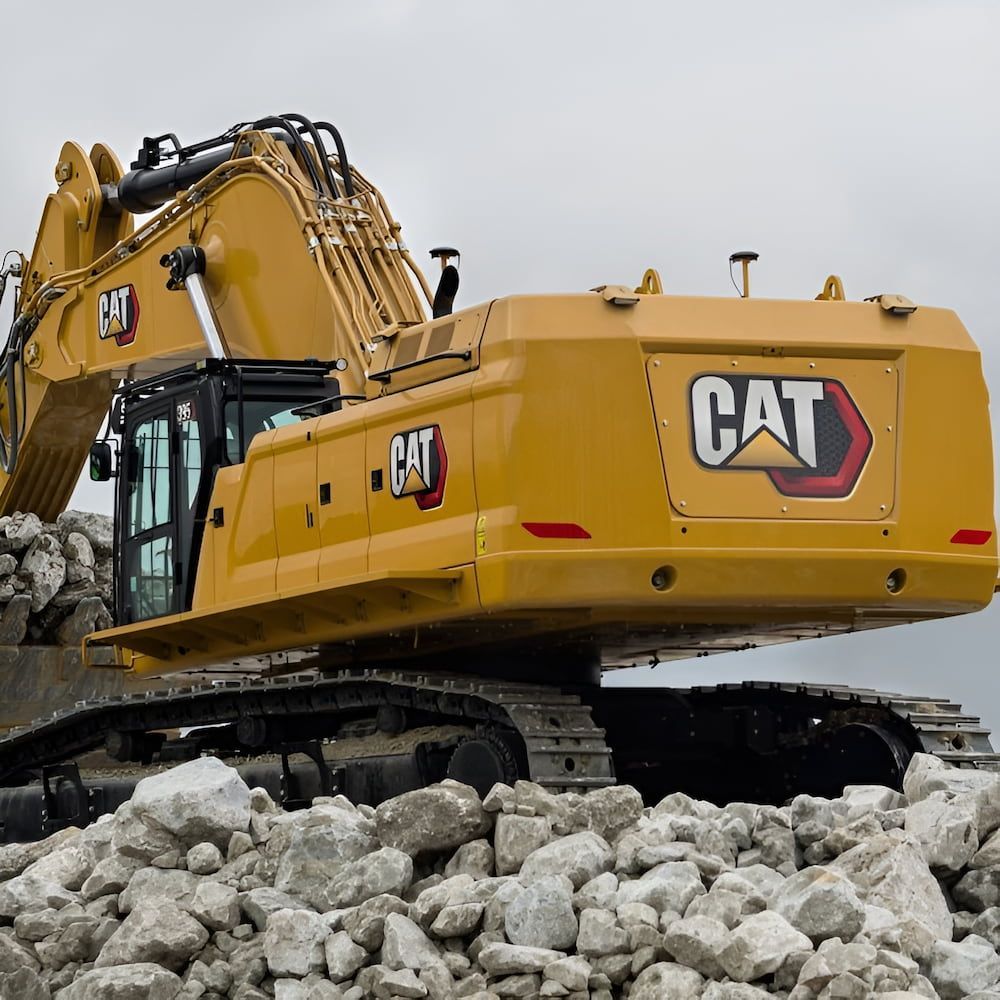 A Cat Excavator Is Sitting On Top Of A Pile Of Rocks — Lohman Contracting in Emerald, QLD
