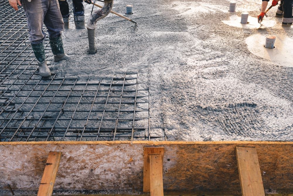 Construction Workers Are Working On A Concrete Floor — Lohman Contracting in Roma, QLD
