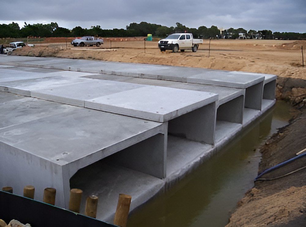 A Muddy Field With A Green Field In The Background — Lohman Contracting in Emerald, QLD