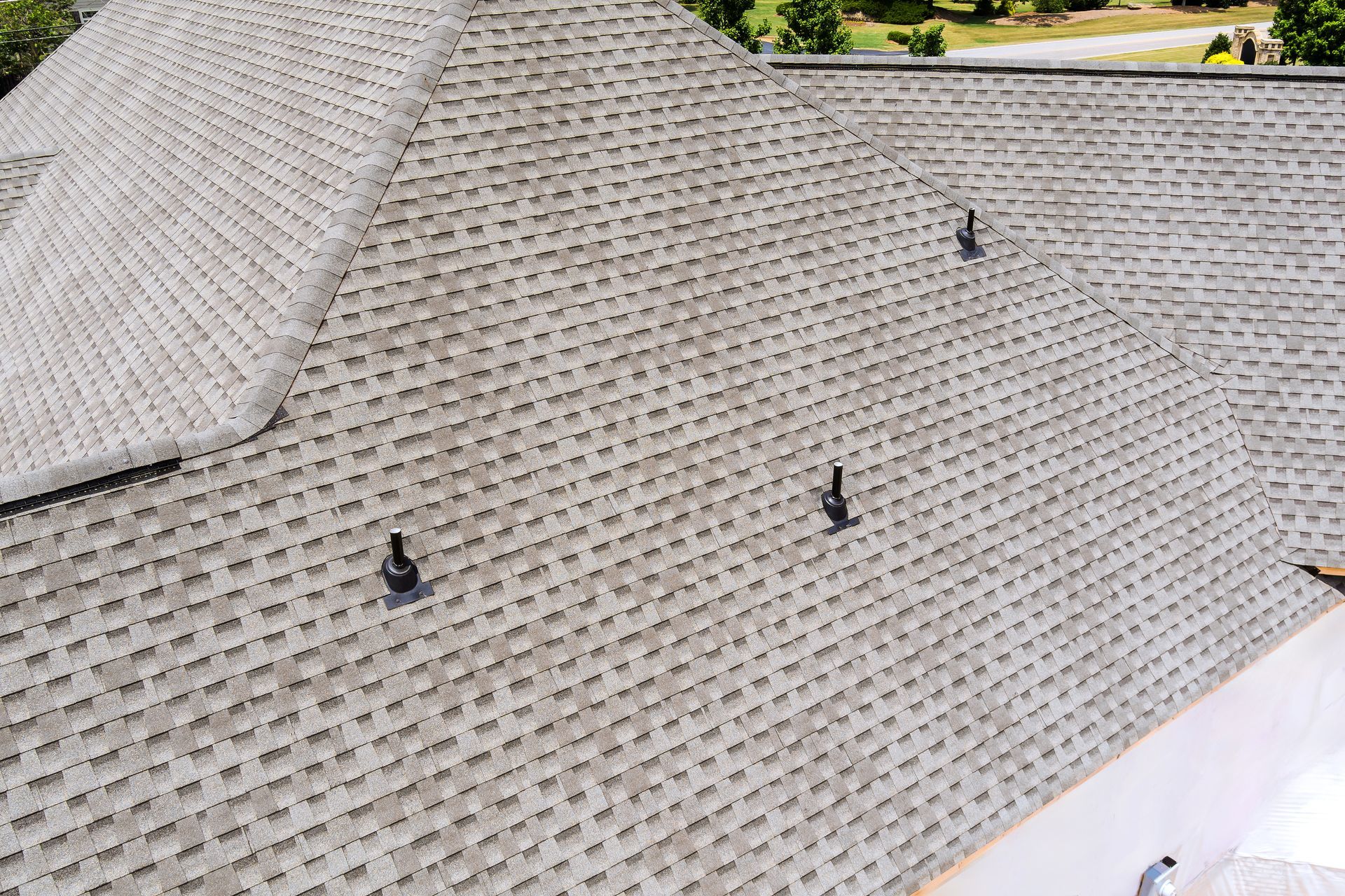Gray shingled roof with three dark vents and a visible roof ridge