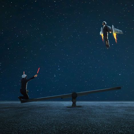 Two figures on a seesaw at night, one seated with a red baton while the other floats above with glowing wings