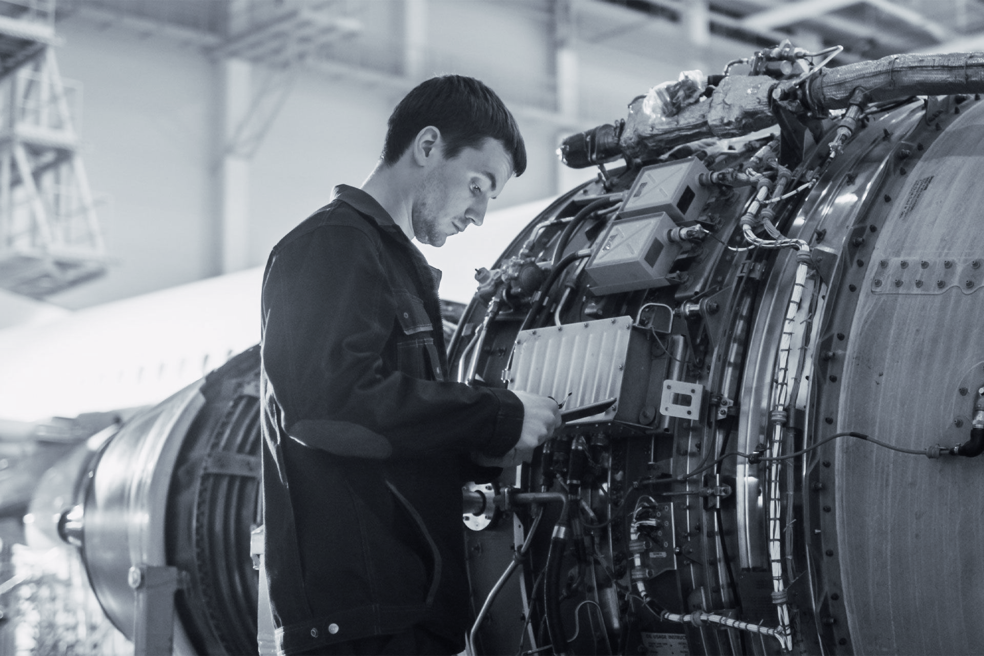 An engineer working on a jet engine