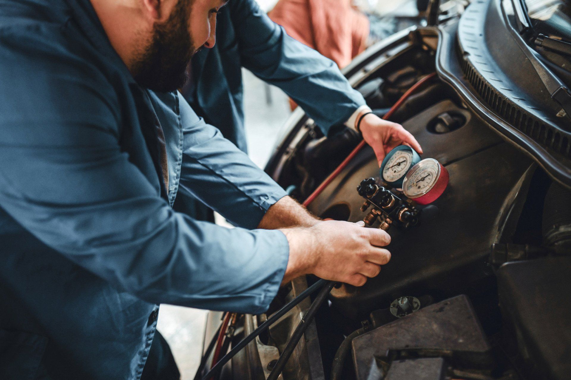Two people checking the aircon of the car | Sydney, NSW | Autocure Mobile Mechanics