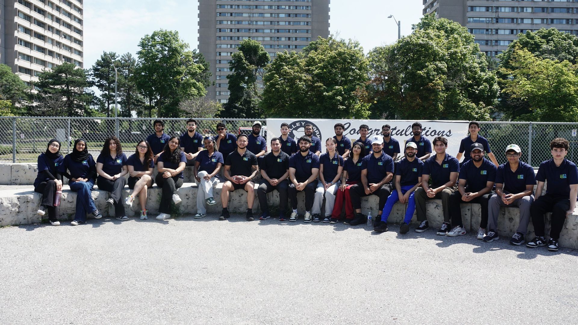 A group of people are posing for a picture in front of a building